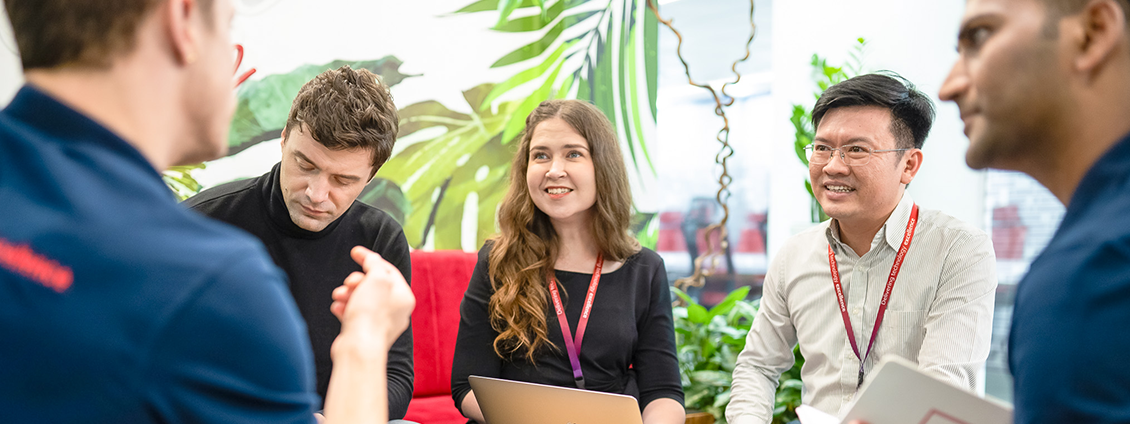 Three people discussing in a meeting